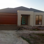 House front with render base and driveway dug out
